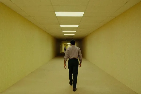 An empty, yellow-walled corridor lit by receding fluorescent ceiling panels — the liminal aesthetic of the Backrooms.